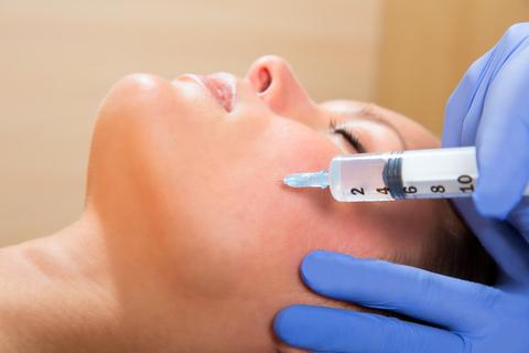 Anti aging facial mesotherapy with syringe closeup  on woman face